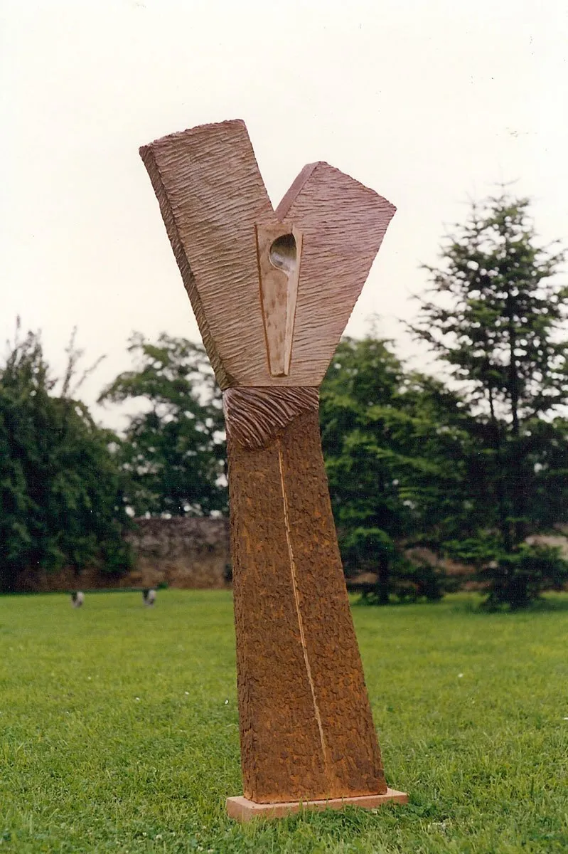 Sculpture with outspread V-shaped wings on a lawn