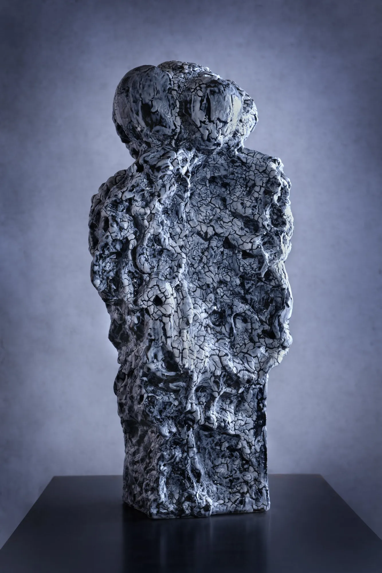 Two-headed figure covered with a cobalt crackle