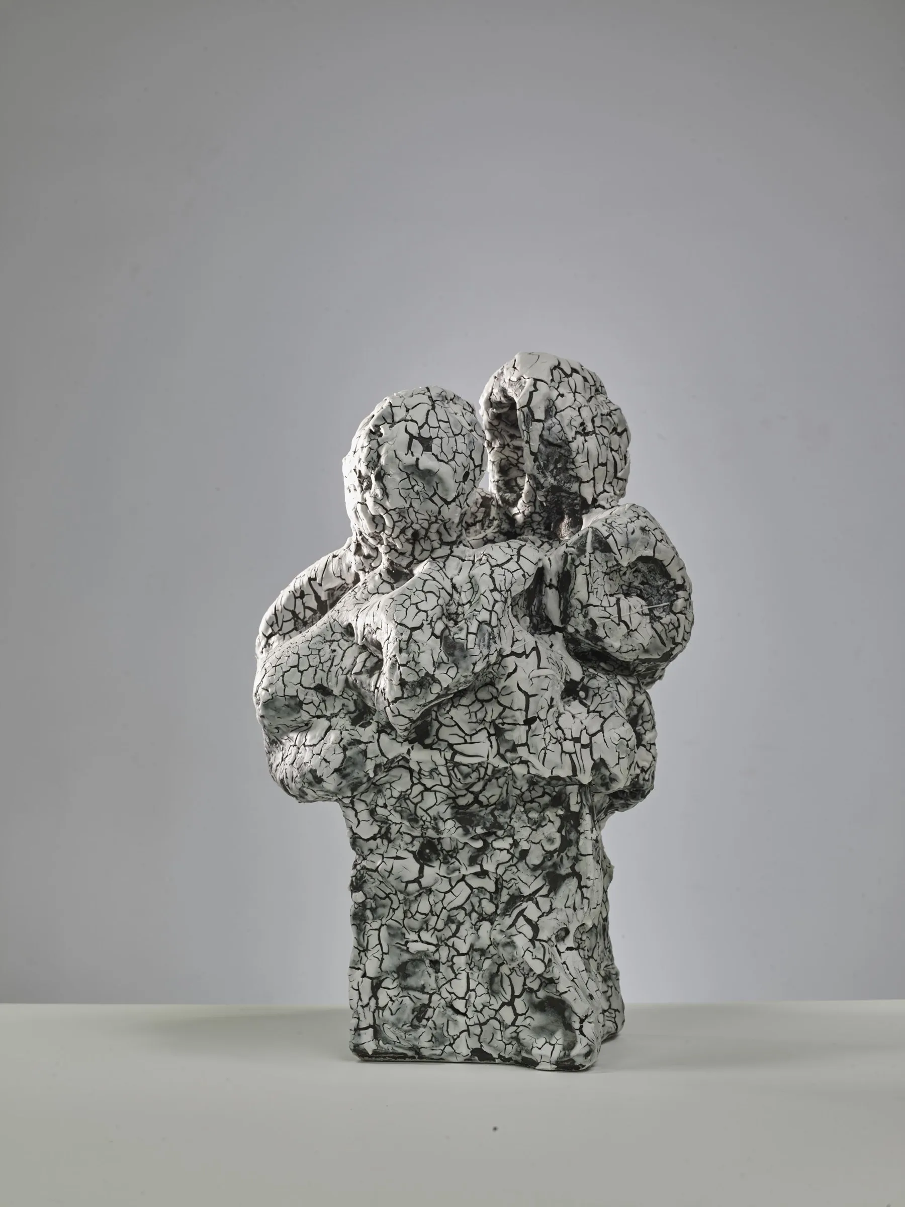 Two-headed sculpture with a circular form, white crackle glaze