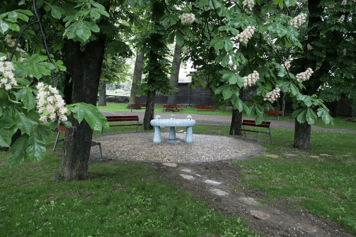 The fountain under flowering chestnut trees in Pernikářka Park